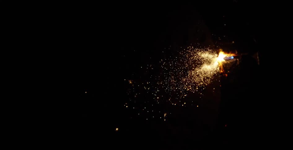 Sparks fly as a tool puts a flame on metal