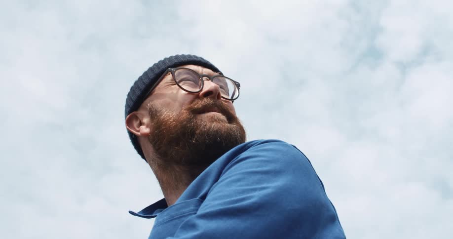 A man is looking up at the sky
