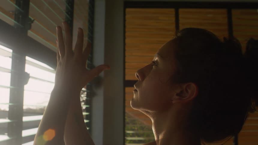 Woman practices yoga at home