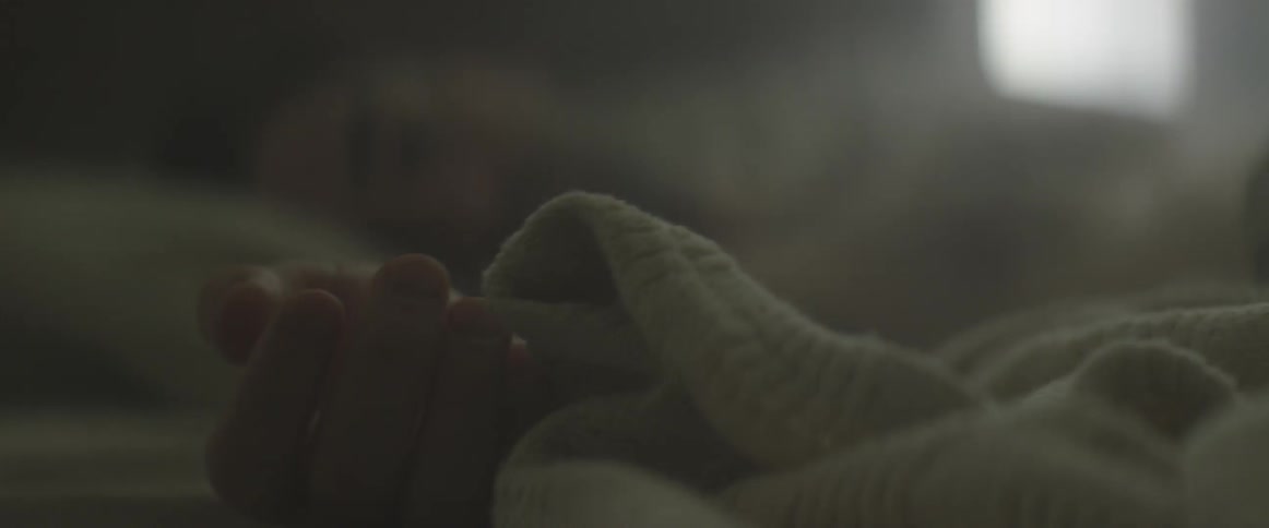 A baby's hand with the fingers moving