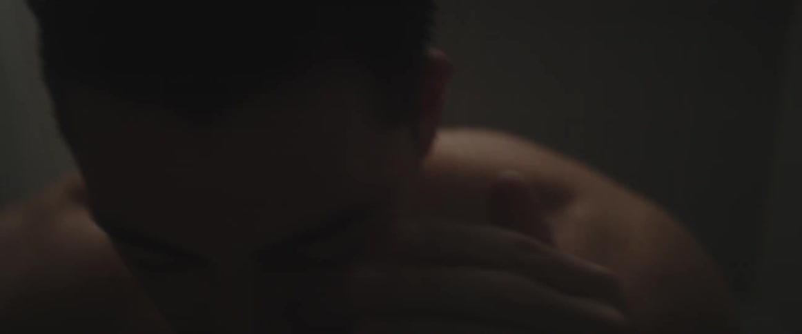 A man wipes his forehead