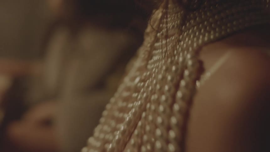 A woman is wearing pearls