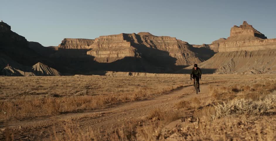 Male cyclist rides a bike on a dirt road