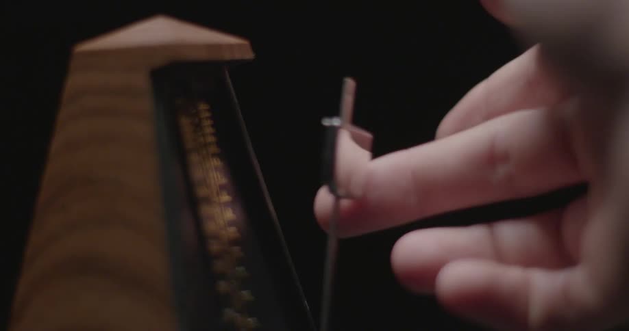 Someone bounces a metronome back and forth