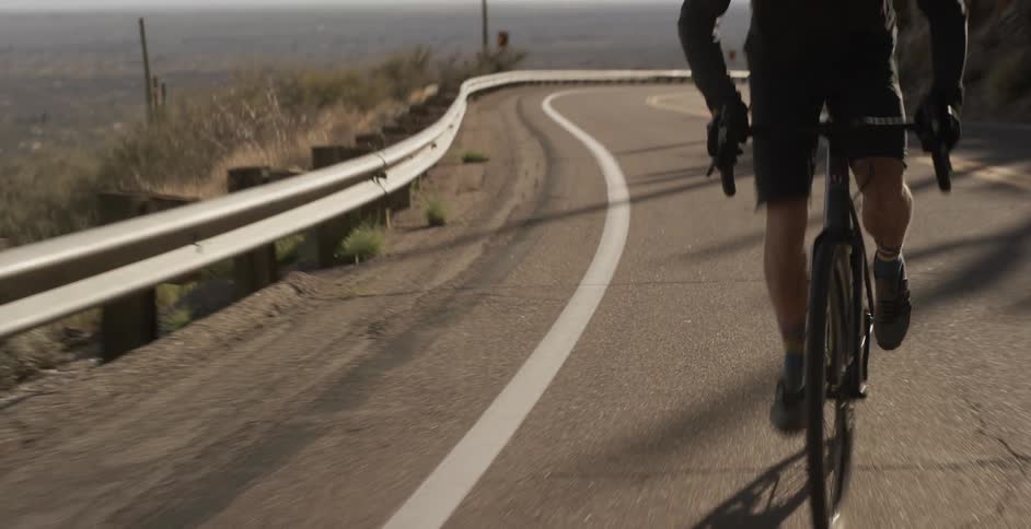 Male cyclist cycles on the mountain road