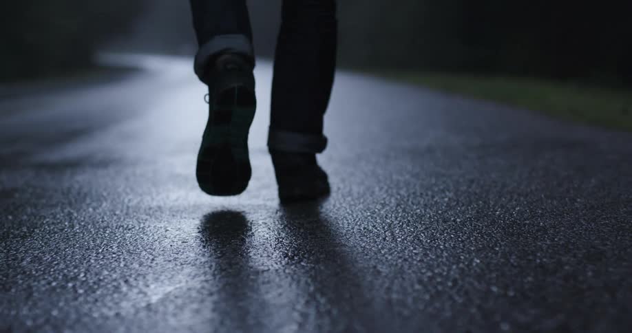 A person walks along the pavement outside