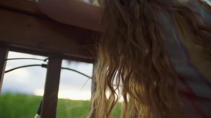 The girl sits on the fence