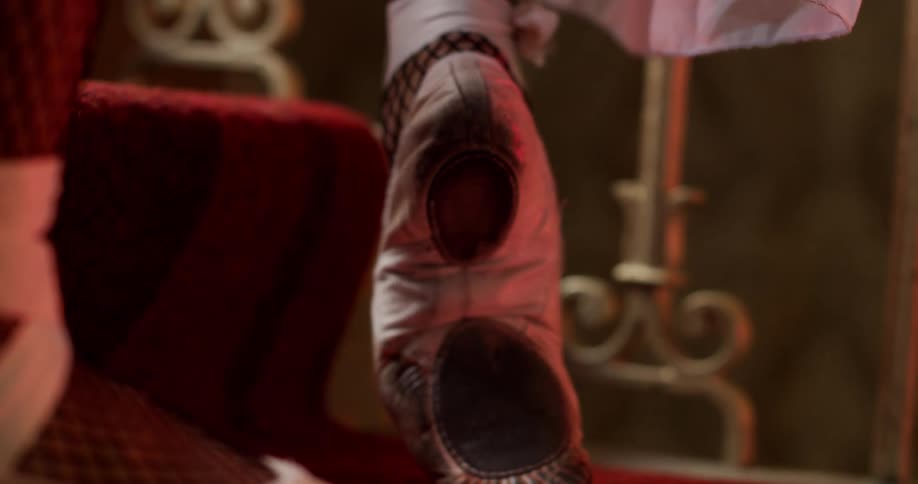 A ballerina does small dance moves on a staircase