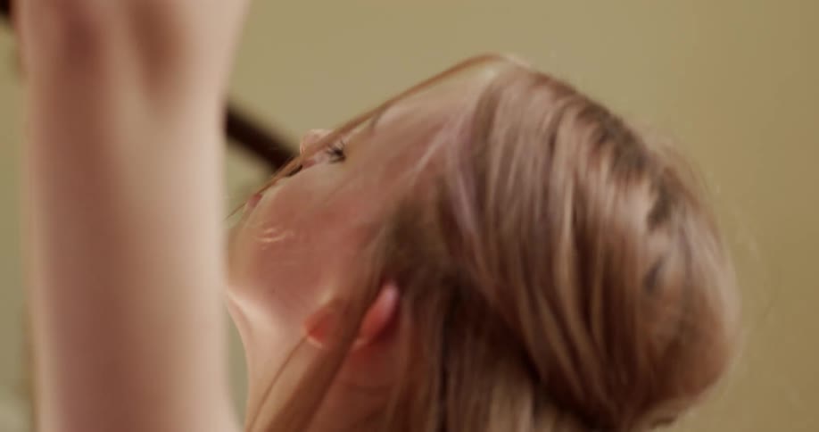 Blonde woman moves her feet and body to the rhythm of music