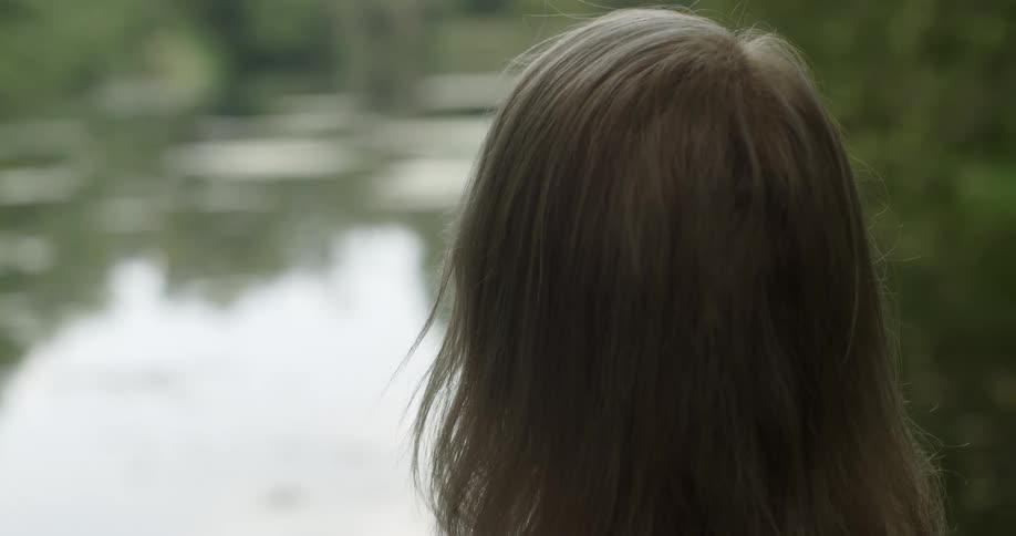 A woman standing by a lake