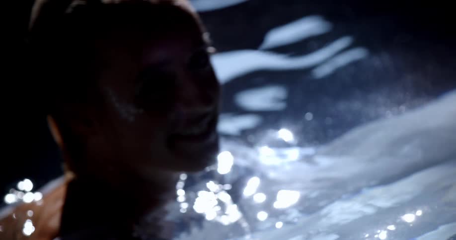A woman in the water wearing a white dress