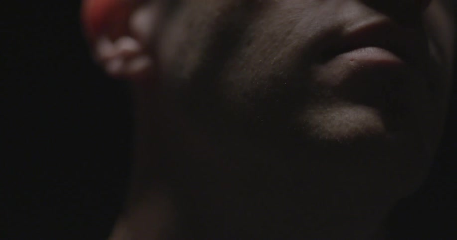 A man looks around a dark room