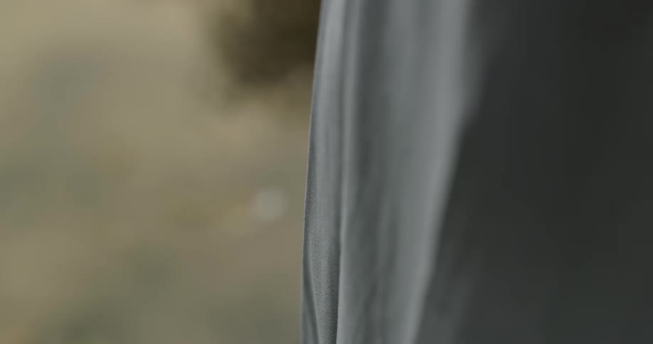 A piece of gray fabric with wrinkles outdoors