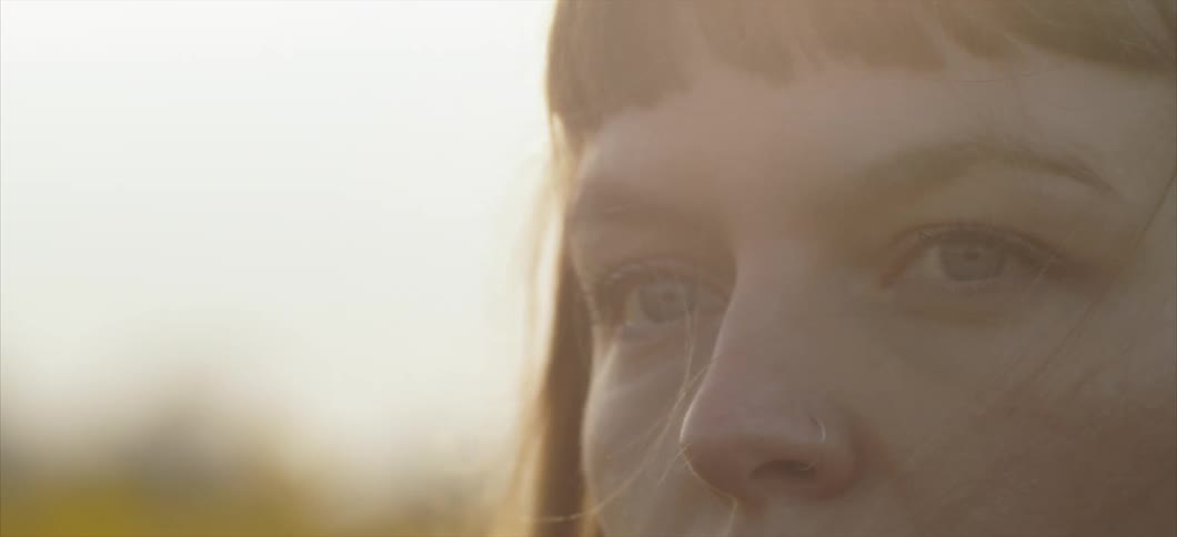 Woman looks around in the field