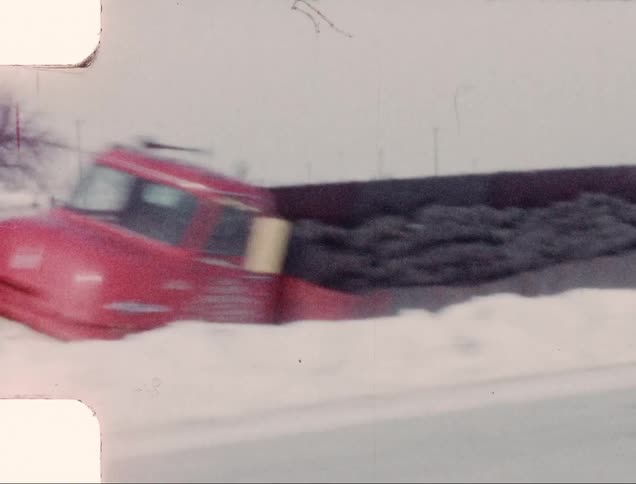A truck hauling rocks stranded in a ditch after a snowstorm