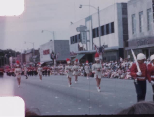 Flagbearers march along in a summer parade