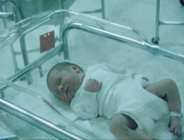 Vintage film of a newborn on a cradle at the hospital