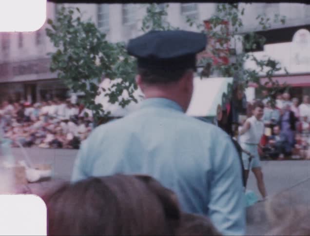 A parade with people dressed up in costumes walking down the street