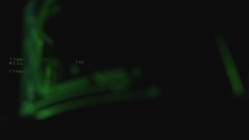 Computer processes flash on a monitor in a dark room