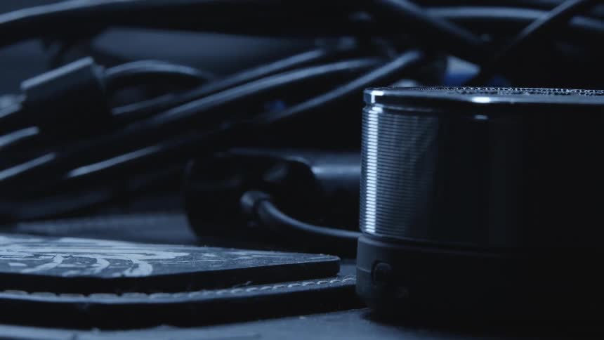 A pile of machinery and cables sit on a table