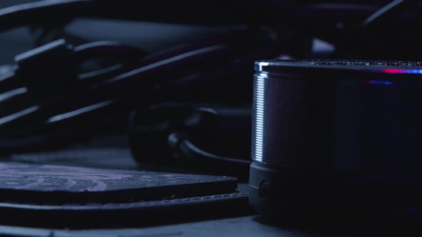 Red and blue lights glows and shine on a round piece of electronic equipment