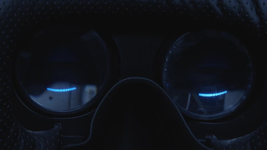 Light moving up and down reflects in lenses of goggles