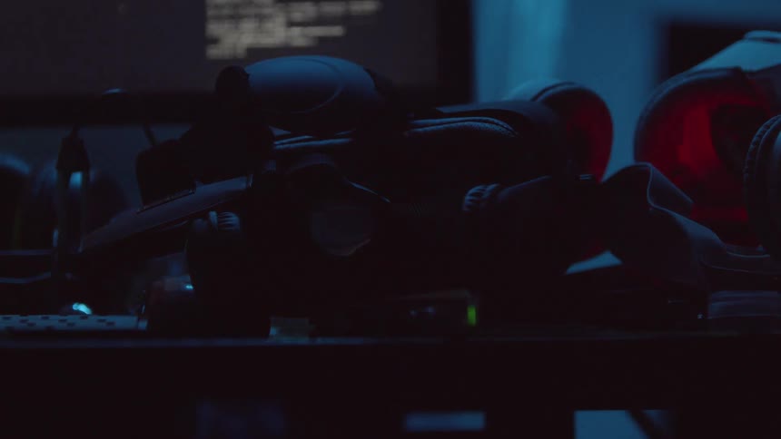 A pile of gear sits on a table as lights flash inside of the pile