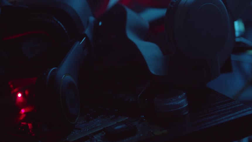 A pile of tech gear with flashing lights indoors