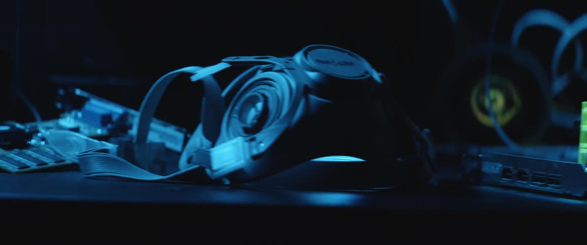 Goggles and a mask with wire and components in the background