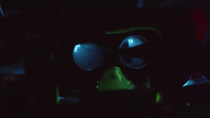 Lights in motion in front of a binocular lens