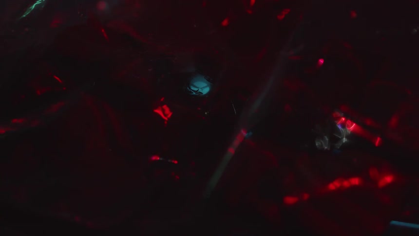 Red and blue lights shine on shadowed board