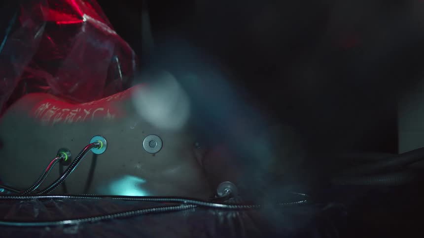 A piece of plastic is pulled off a human looking robot