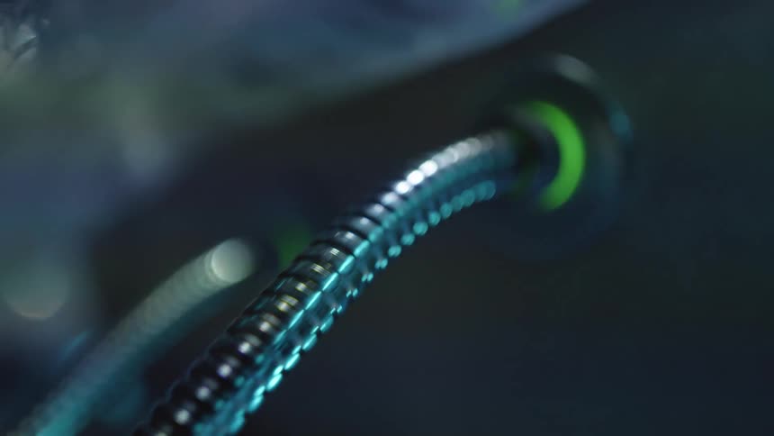 A metal cable runs to a lighted connection in a persons back