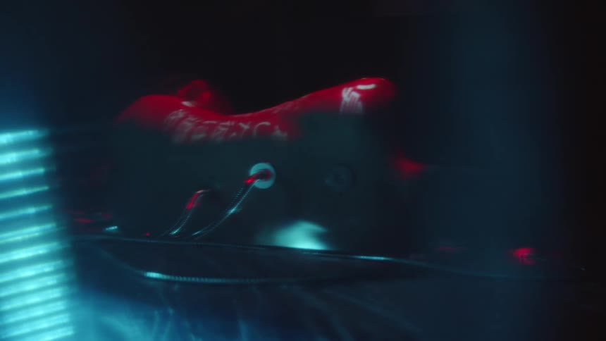 A person laying down with wires coming out their back