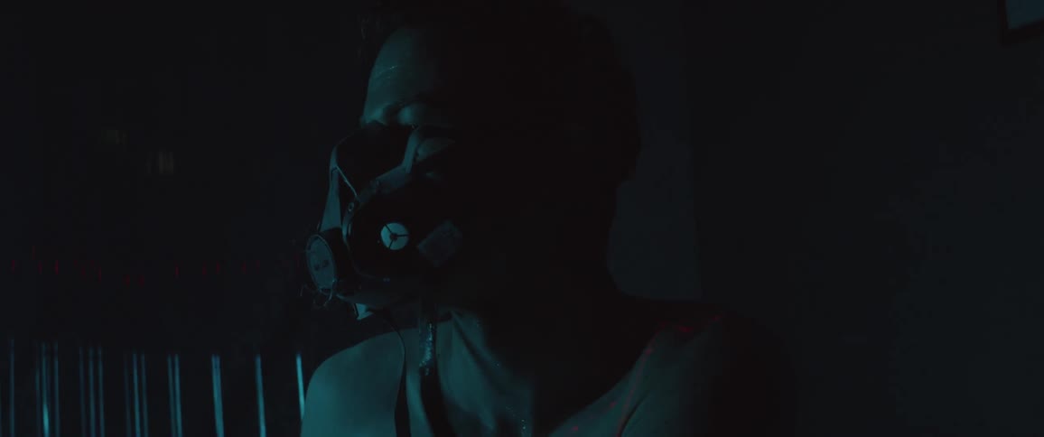 A white person pulls off a tube connected to a face mask