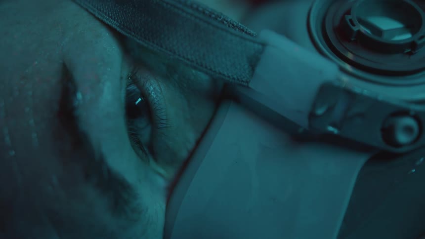 A persons eye blinking while they are wearing a mask