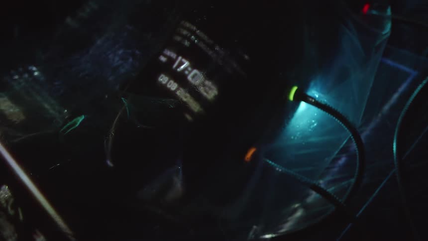 Cables with flickering lights attached to a bag with text flashing on it