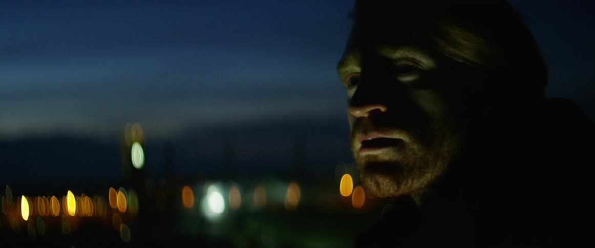 Man looks at the phone screen at night