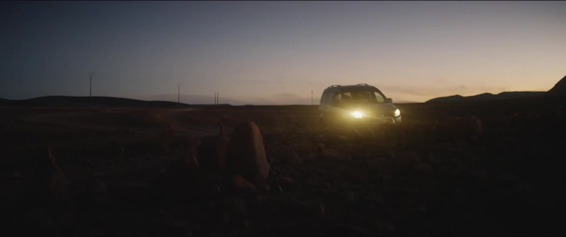 The car drives in the darkness