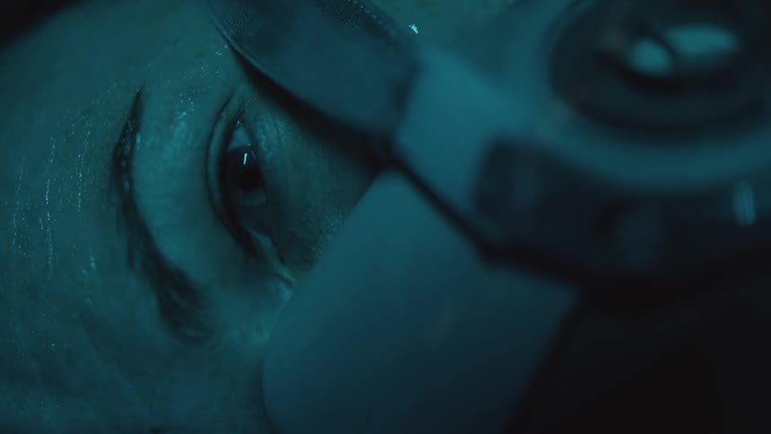 A white person with a mask on their face pops their eye open
