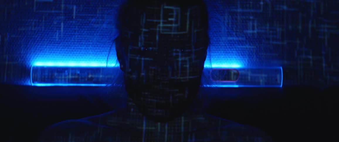 Light designs flash on a human head hooked up to wires