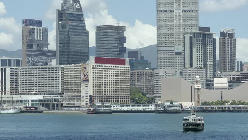 A boat on the water in front of a city skyline