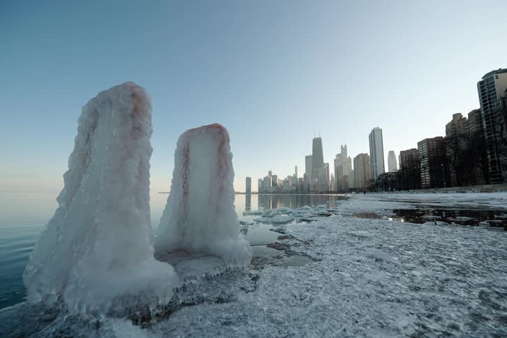 Glaciers with a coastal city and people in the background