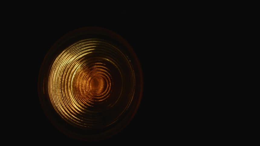 A gold colored metal disc bounces around