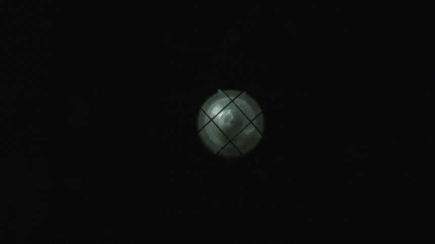 A light fixture with darkness in the background