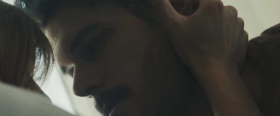 Woman caresses mans face as he leans closer to her