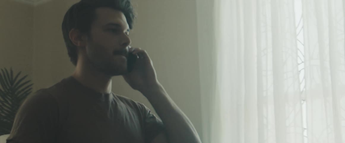 A man talks on his cell phone in his home
