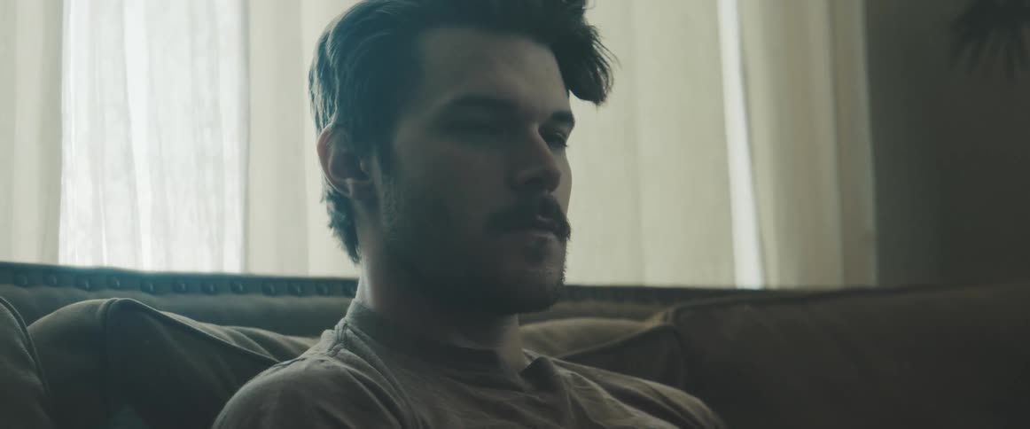 Man sits on the sofa in the living room