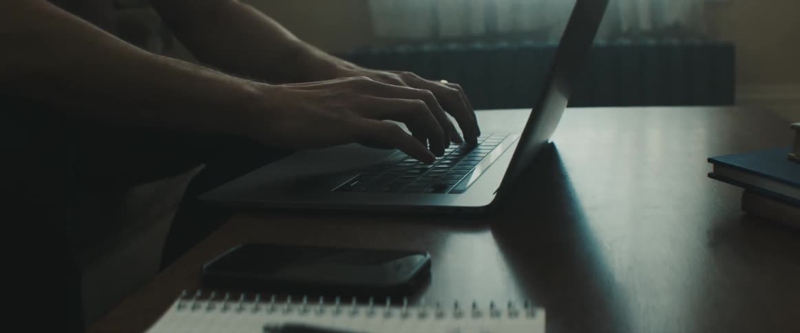 Man sitting on the sofa uses a laptop in the living room