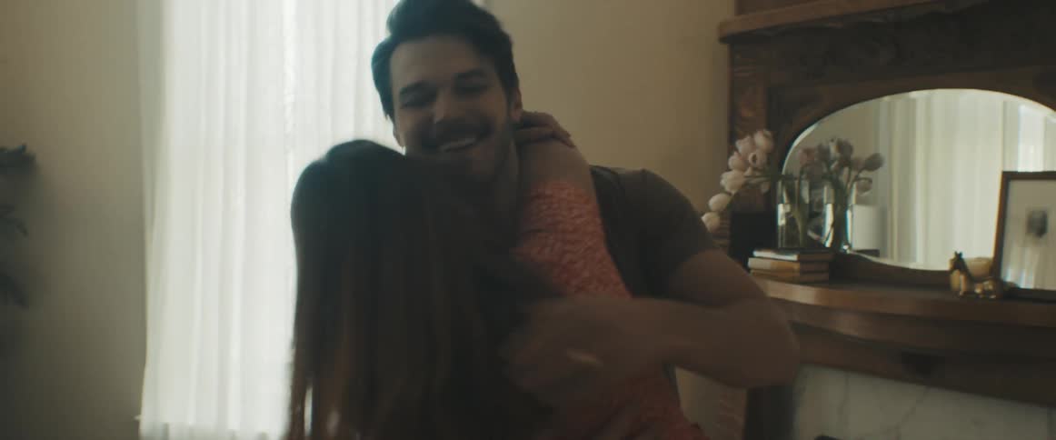 A man and woman hug and dance